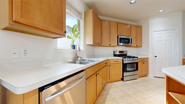 2702 Skyview Moon Dr, Houston, TX 77047 - kitchen with appliances with stainless steel finishes, a sink, light countertops, recessed lighting, and light floors
