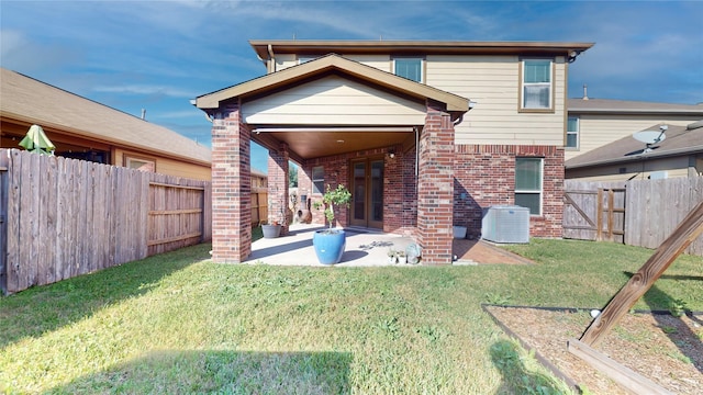 2702 Skyview Moon Dr, Houston, TX 77047 - back of property featuring brick siding, central AC, and a patio area