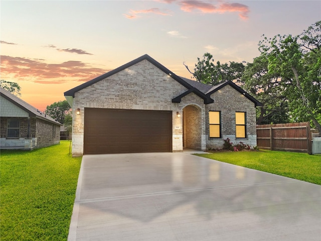 518 S 4th St, La Porte, TX 77571 - french country style house featuring brick siding, an attached garage, and concrete driveway