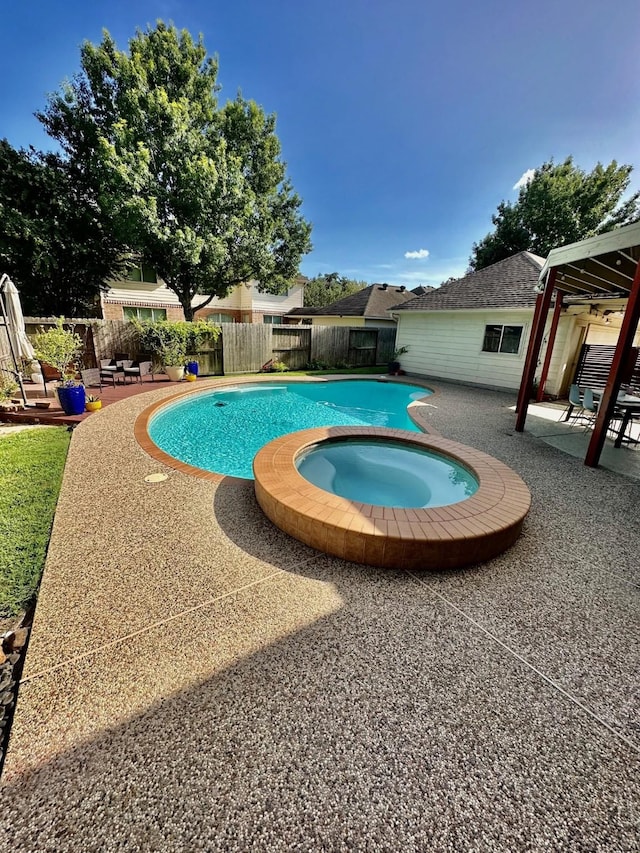 19203 Yearling Mdws, Houston, TX 77094 - view of swimming pool with a fenced backyard, a patio area, and a pool with connected hot tub