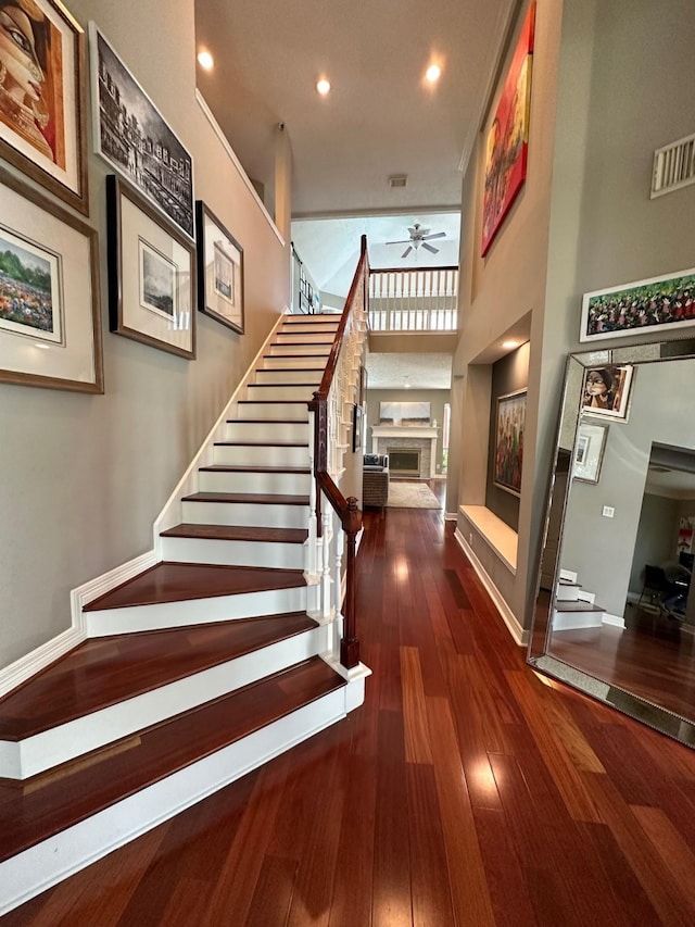 19203 Yearling Mdws, Houston, TX 77094 - stairs with a fireplace, ceiling fan, baseboards, wood-type flooring, and recessed lighting