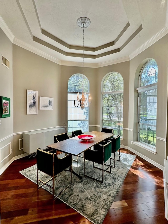 19203 Yearling Mdws, Houston, TX 77094 - dining area with a tray ceiling, hardwood / wood-style flooring, a chandelier, crown molding, and baseboards