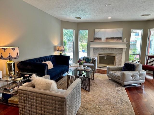 19203 Yearling Mdws, Houston, TX 77094 - living room featuring a textured ceiling, plenty of natural light, hardwood / wood-style floors, and a fireplace