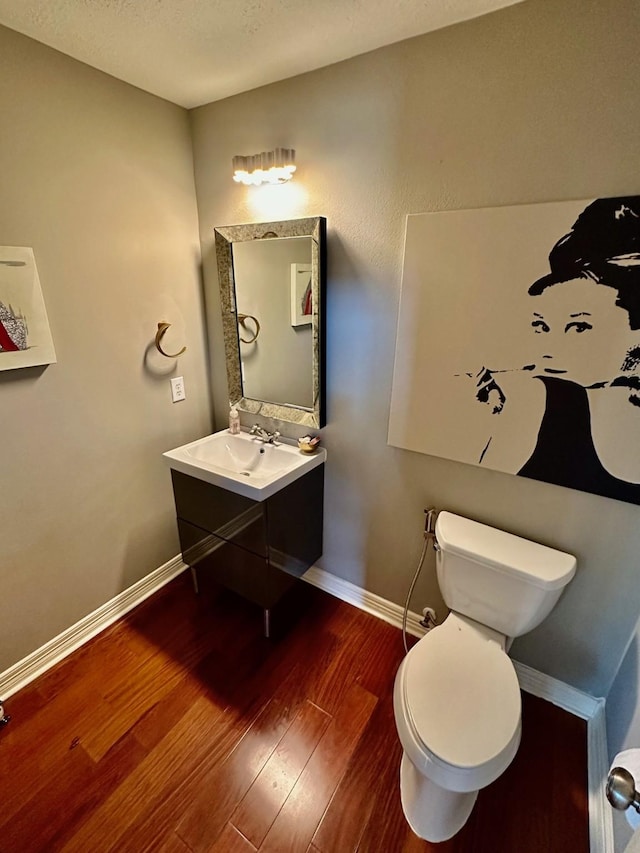 19203 Yearling Mdws, Houston, TX 77094 - half bathroom with wood finished floors, baseboards, toilet, and vanity