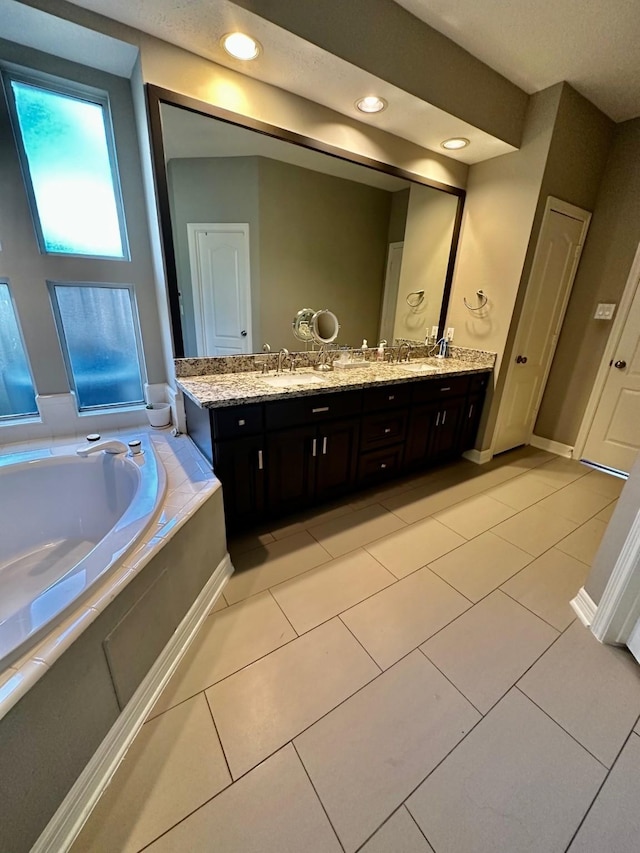 19203 Yearling Mdws, Houston, TX 77094 - full bathroom with a bath, double vanity, tile patterned floors, and baseboards