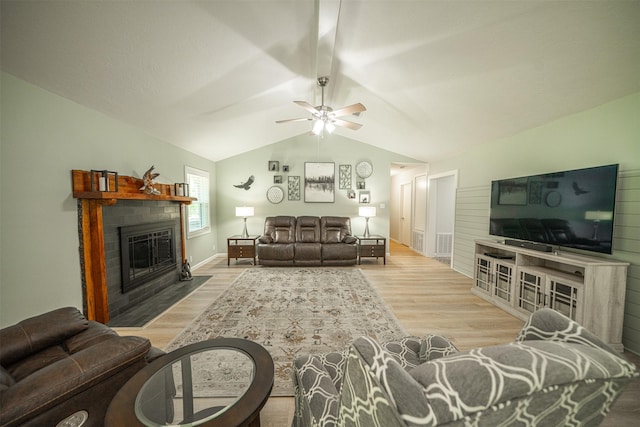 1191 Barnum Blvd, Corrigan, TX 75939 - living area with wood finished floors, a fireplace with flush hearth, a ceiling fan, and vaulted ceiling