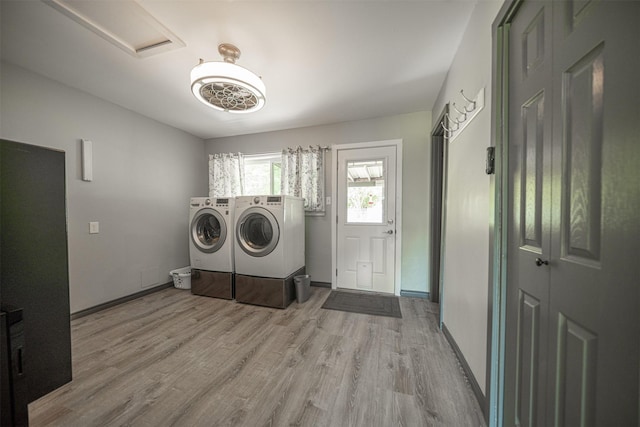 1191 Barnum Blvd, Corrigan, TX 75939 - clothes washing area with separate washer and dryer, wood finished floors, and baseboards