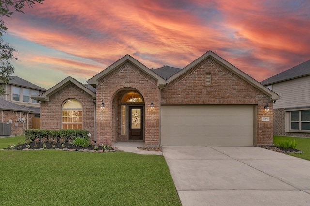 31766 Chapel Rock Ln, Spring, TX 77386 - view of front of house featuring brick siding, central AC unit, and a yard