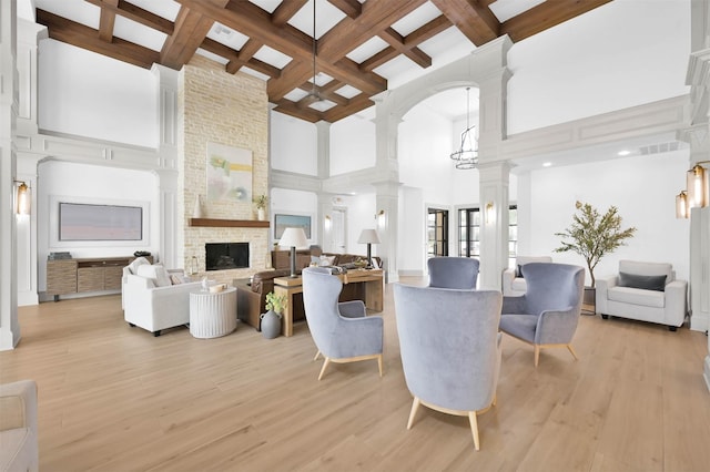 31766 Chapel Rock Ln, Spring, TX 77386 - living room featuring coffered ceiling, ornate columns, a large fireplace, a towering ceiling, and beam ceiling