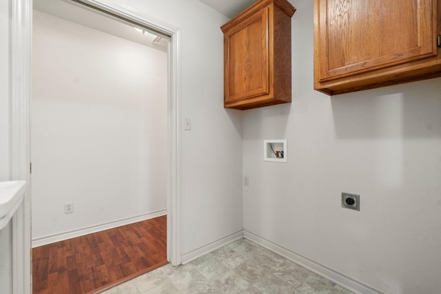 185 Rustic Way, Livingston, TX 77351 - washroom with hookup for an electric dryer, hookup for a washing machine, baseboards, and cabinet space