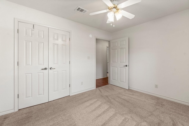 185 Rustic Way, Livingston, TX 77351 - unfurnished bedroom featuring carpet flooring, a closet, baseboards, and ceiling fan