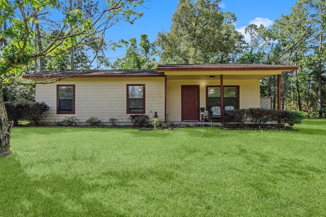 185 Rustic Way, Livingston, TX 77351 - ranch-style house featuring a front yard and covered porch