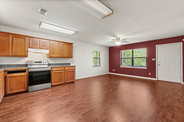185 Rustic Way, Livingston, TX 77351 - kitchen featuring electric stove, under cabinet range hood, wood finished floors, a ceiling fan, and brown cabinetry