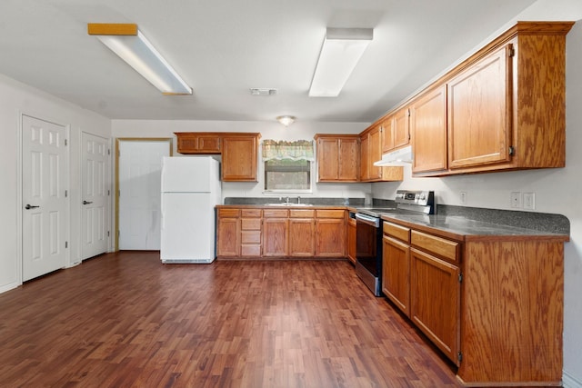 185 Rustic Way, Livingston, TX 77351 - kitchen featuring freestanding refrigerator, stainless steel range with electric stovetop, under cabinet range hood, dark countertops, and dark wood-type flooring