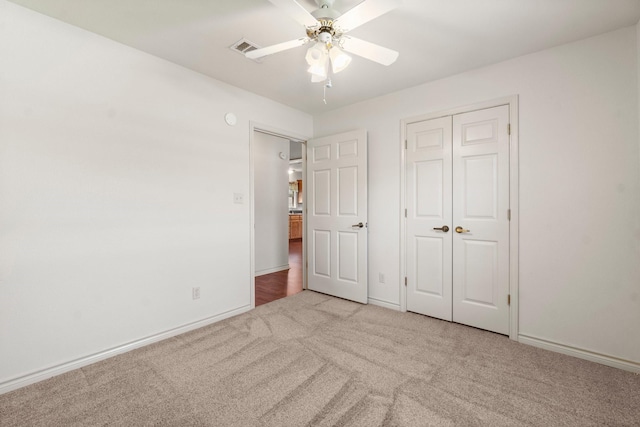 185 Rustic Way, Livingston, TX 77351 - unfurnished bedroom with carpet flooring, ceiling fan, a closet, and baseboards