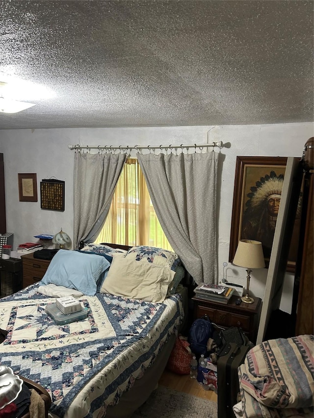 26735 Saddle Rock Ln, New Caney, TX 77357 - bedroom with a textured ceiling and wood finished floors
