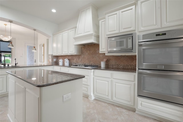 18011 Stari Most Ln, Houston, TX 77044 - kitchen featuring stainless steel appliances, a sink, custom exhaust hood, decorative backsplash, and dark stone countertops