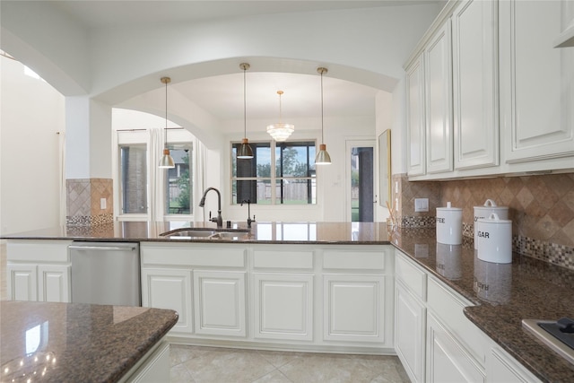 18011 Stari Most Ln, Houston, TX 77044 - kitchen featuring a sink, dishwasher, dark stone counters, and white cabinetry
