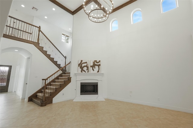 18011 Stari Most Ln, Houston, TX 77044 - unfurnished living room featuring a towering ceiling, stairs, plenty of natural light, a chandelier, and tile patterned floors