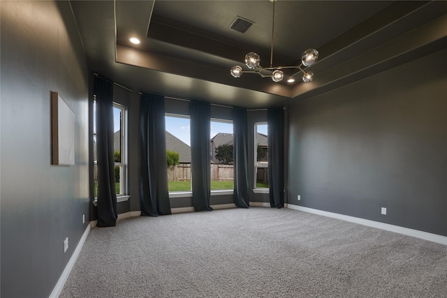 18011 Stari Most Ln, Houston, TX 77044 - empty room with a raised ceiling, carpet, baseboards, and a chandelier