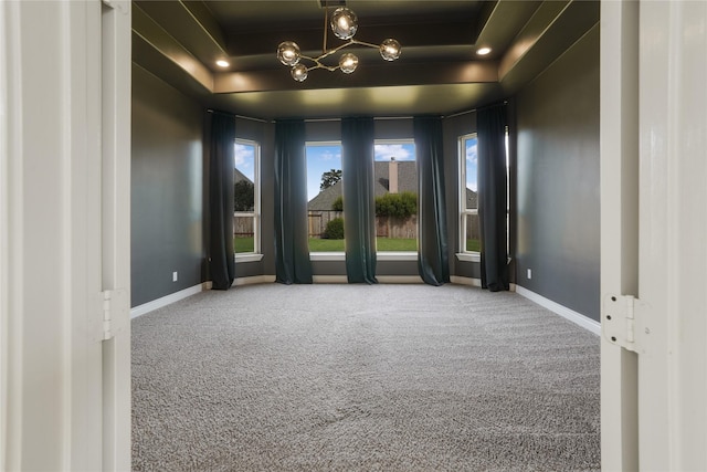 18011 Stari Most Ln, Houston, TX 77044 - empty room featuring carpet floors, baseboards, a chandelier, and a raised ceiling