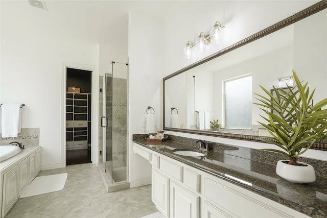 18011 Stari Most Ln, Houston, TX 77044 - bathroom with a shower stall, vanity, a garden tub, tile patterned floors, and baseboards