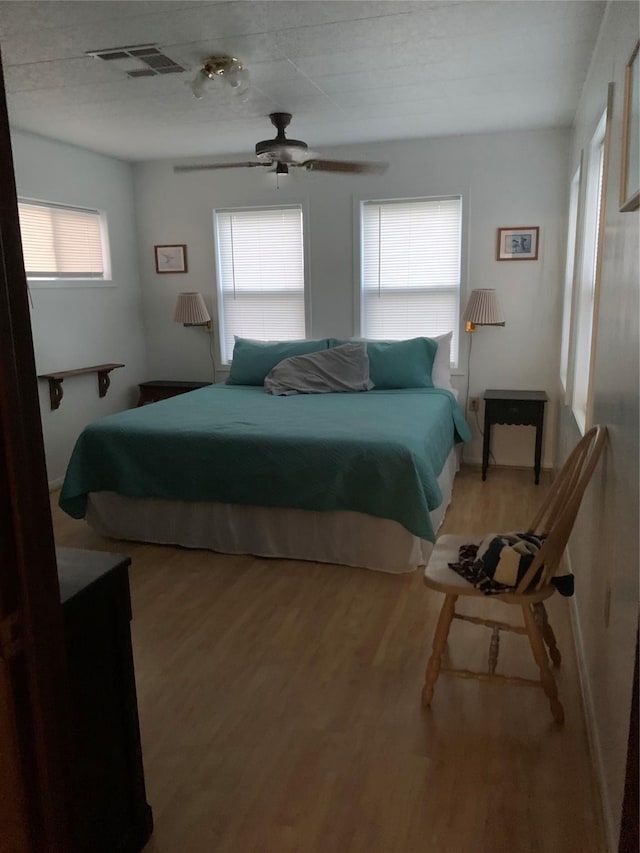 142 Seagull, Sargent, TX 77414 - bedroom featuring light wood finished floors and a ceiling fan