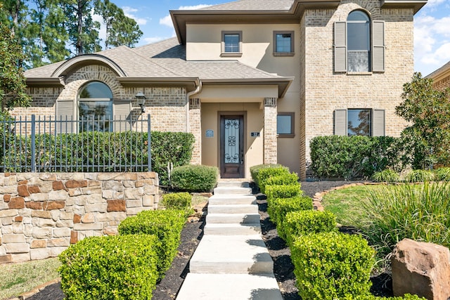 32 Evangeline Blvd, Conroe, TX 77304 - view of front of house with roof with shingles, brick siding, and stucco siding