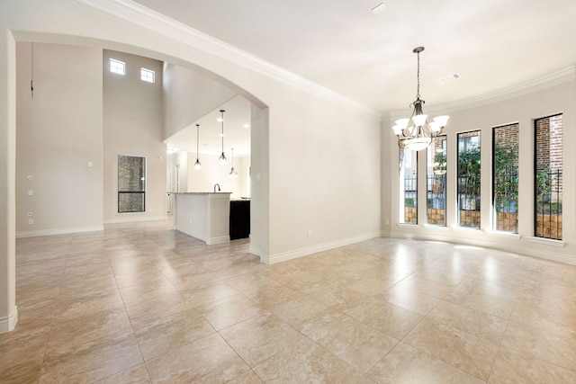 32 Evangeline Blvd, Conroe, TX 77304 - unfurnished living room featuring healthy amount of natural light, a chandelier, crown molding, arched walkways, and baseboards
