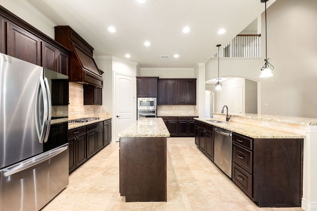 32 Evangeline Blvd, Conroe, TX 77304 - kitchen with stainless steel appliances, an island with sink, a sink, arched walkways, and crown molding