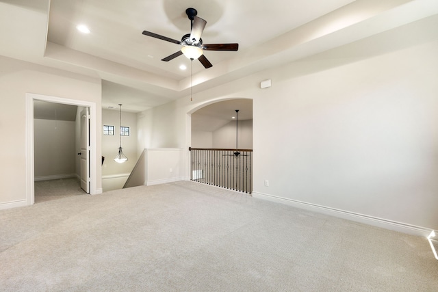 32 Evangeline Blvd, Conroe, TX 77304 - carpeted empty room with a ceiling fan, a tray ceiling, recessed lighting, and baseboards