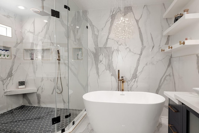 15232 Saddlewood Dr, Conroe, TX 77384 - bathroom featuring a marble finish shower, marble tiled floors, vanity, a freestanding bath, and tile walls