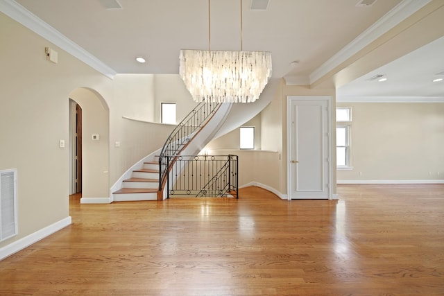 2019 Driscoll St Unit B, Houston, TX 77019 - unfurnished room with crown molding, baseboards, a chandelier, arched walkways, and wood finished floors