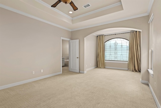 2019 Driscoll St Unit B, Houston, TX 77019 - unfurnished bedroom with light carpet, a tray ceiling, baseboards, crown molding, and arched walkways