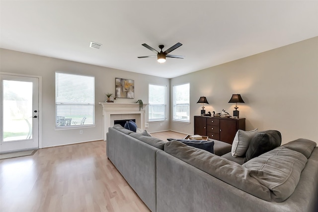 17006 Valley Palms Dr, Spring, TX 77379 - living area featuring ceiling fan, light wood-style floors, and a tiled fireplace