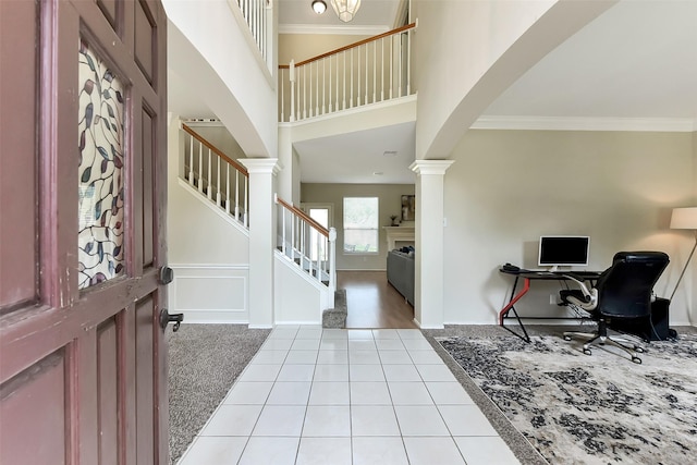17006 Valley Palms Dr, Spring, TX 77379 - foyer featuring ornate columns, light tile patterned flooring, a high ceiling, stairway, and ornamental molding