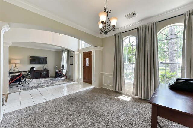 17006 Valley Palms Dr, Spring, TX 77379 - carpeted foyer entrance with arched walkways, ornamental molding, ornate columns, a chandelier, and tile patterned floors