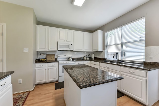 17006 Valley Palms Dr, Spring, TX 77379 - kitchen with white appliances, a sink, tasteful backsplash, and white cabinets