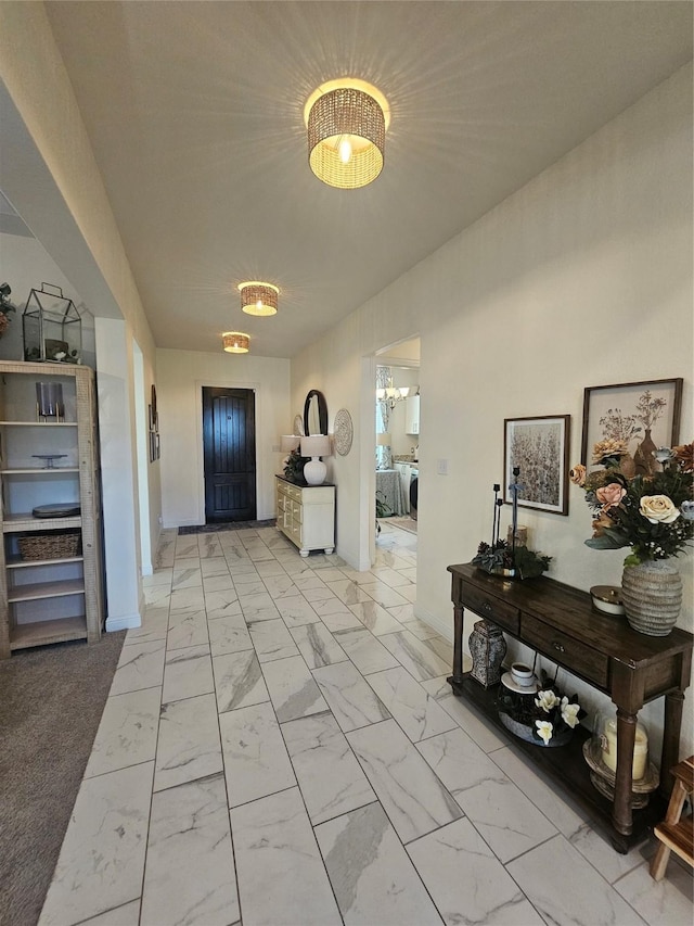 1013 Goose Creek St, Webster, TX 77598 - hallway featuring independent washer and dryer and light marble finish flooring