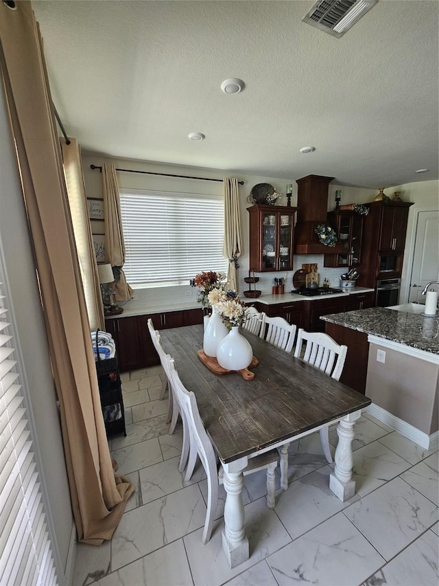 1013 Goose Creek St, Webster, TX 77598 - dining room with light marble finish flooring and a textured ceiling