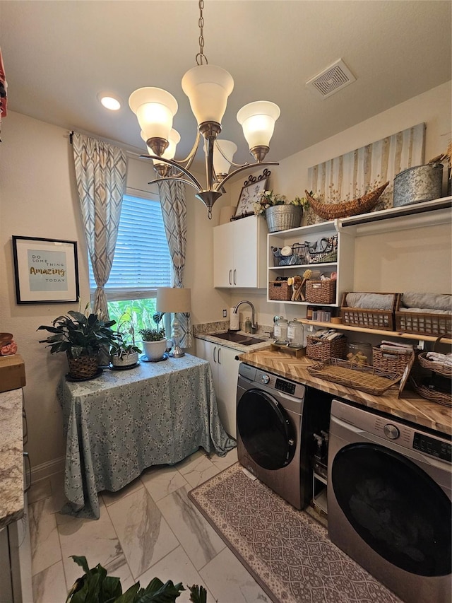 1013 Goose Creek St, Webster, TX 77598 - laundry area with washing machine and clothes dryer, light marble finish flooring, cabinet space, a chandelier, and recessed lighting