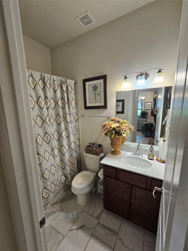 1013 Goose Creek St, Webster, TX 77598 - bathroom with marble look tile flooring, vanity, a textured wall, and a shower with shower curtain