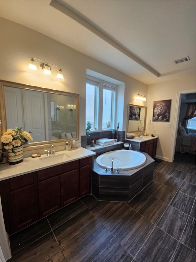1013 Goose Creek St, Webster, TX 77598 - ensuite bathroom with a garden tub, two vanities, and a shower
