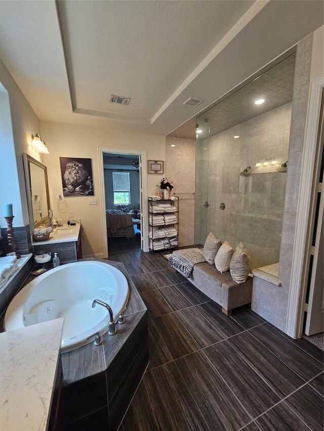 1013 Goose Creek St, Webster, TX 77598 - ensuite bathroom with a garden tub, vanity, a walk in shower, and a textured ceiling