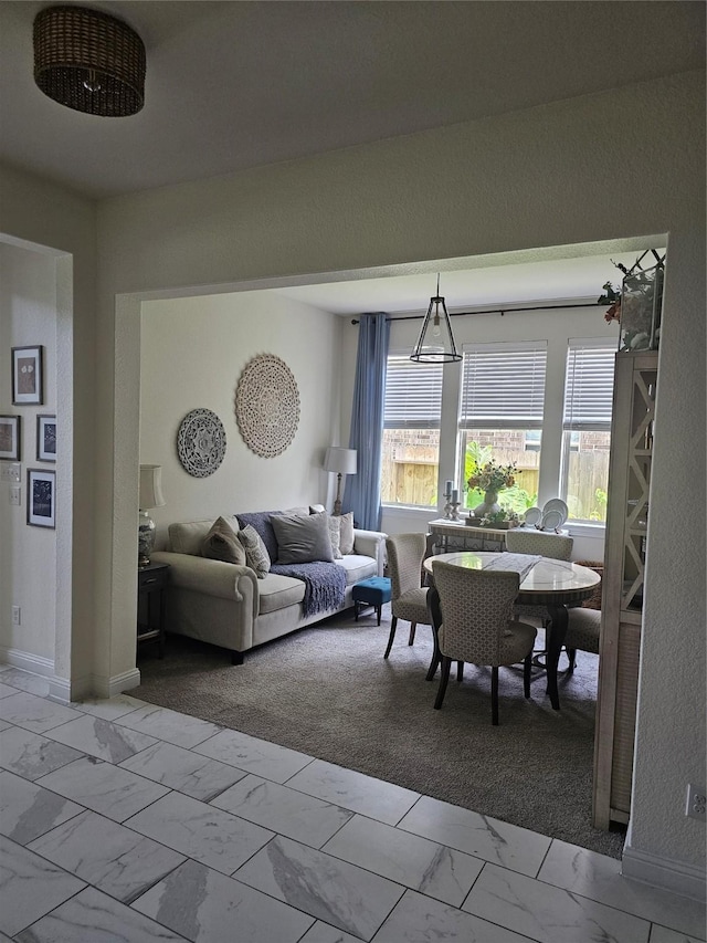 1013 Goose Creek St, Webster, TX 77598 - living room featuring light marble finish flooring and baseboards