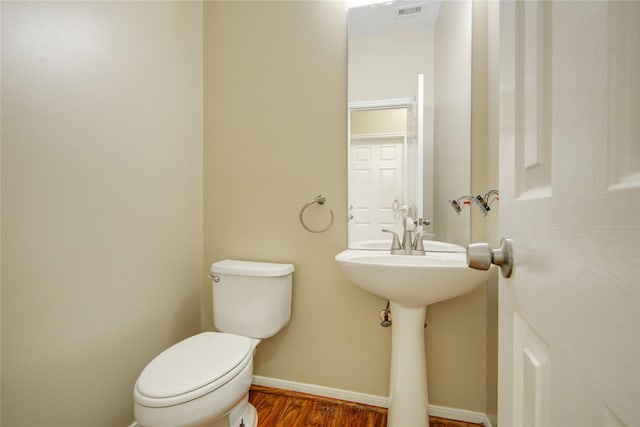 10900 Spruce Dr N, La Porte, TX 77571 - half bath with wood finished floors, toilet, and baseboards