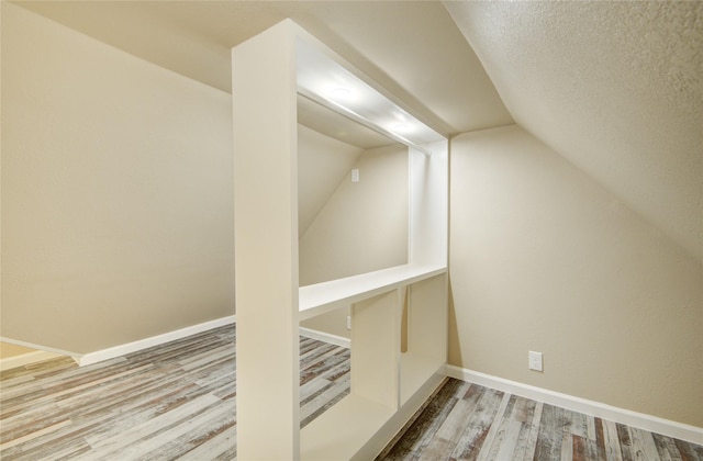 10900 Spruce Dr N, La Porte, TX 77571 - bonus room with wood finished floors, vaulted ceiling, and baseboards
