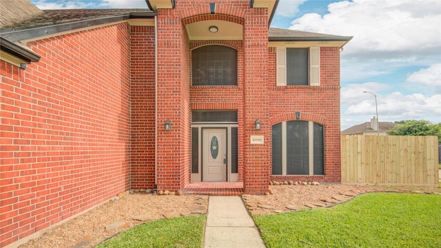 10900 Spruce Dr N, La Porte, TX 77571 - view of front of house with brick siding, fence, and roof with shingles