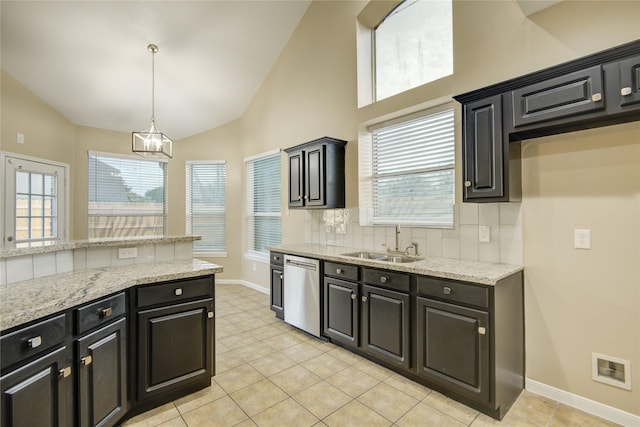 10900 Spruce Dr N, La Porte, TX 77571 - kitchen featuring a sink, stainless steel dishwasher, baseboards, dark cabinets, and high vaulted ceiling