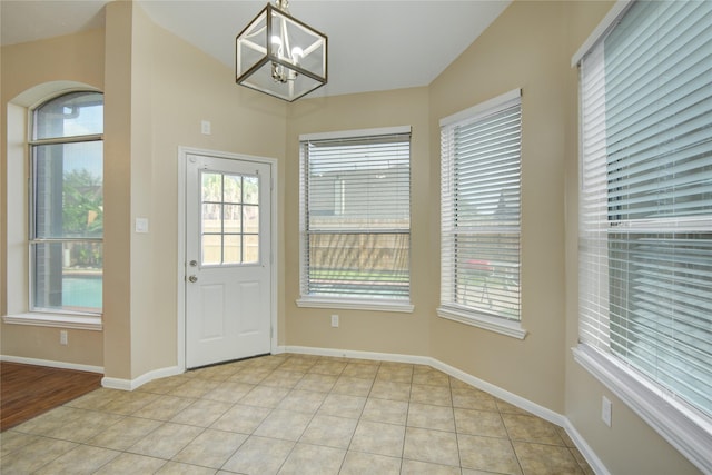 10900 Spruce Dr N, La Porte, TX 77571 - doorway to outside with a chandelier, baseboards, and light tile patterned floors